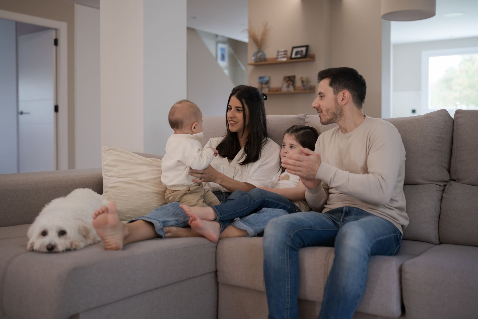 Happy family with dog relaxing in Sandy Springs living room - pet-friendly professional rug cleaning services in Atlanta GA