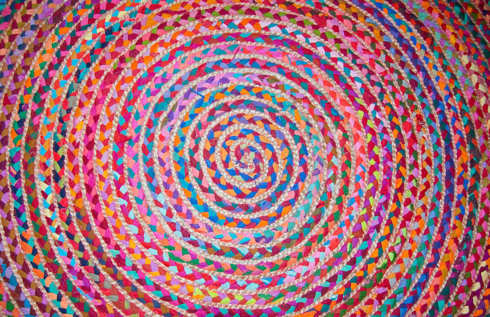 Colorful circular round fabric woven carpet pattern background.