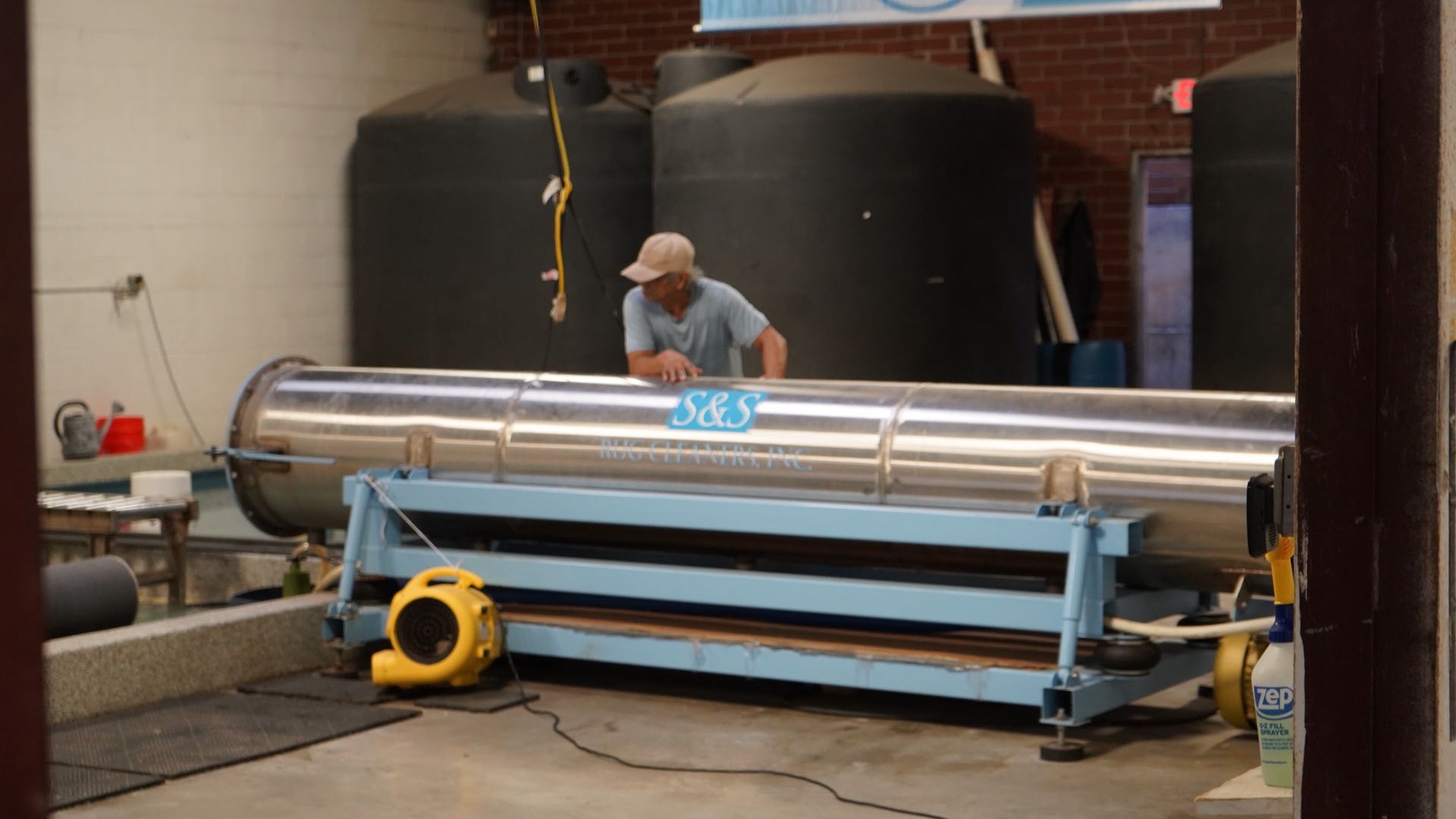 Centrifuge wringer at the S&S Rug Cleaners Atlanta plant used to extract water from a washed wool rug before controlled drying