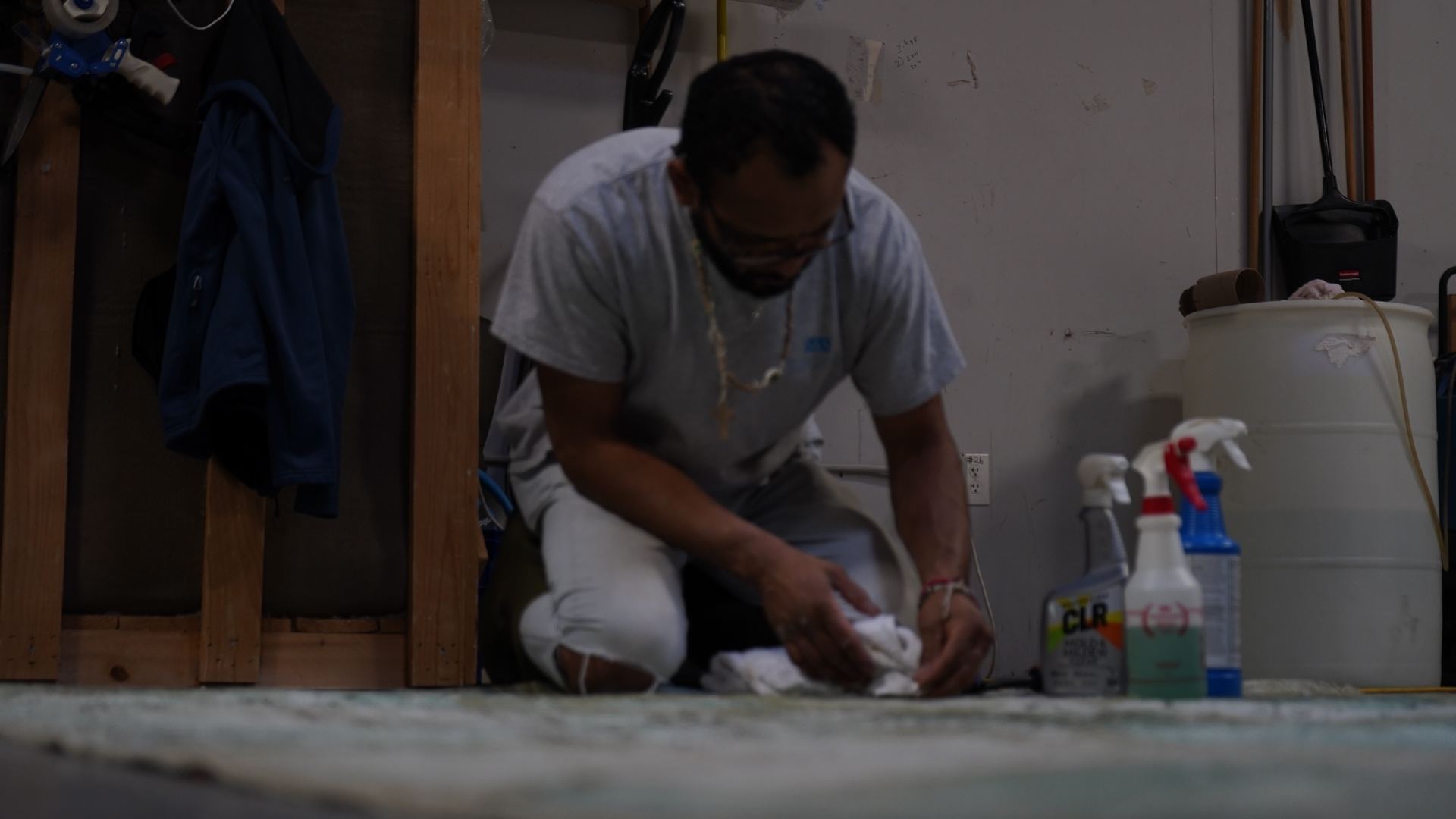 S&S Rug Cleaners technician blotting a stain on an area rug with a white cloth, the low-moisture method safe for viscose rugs