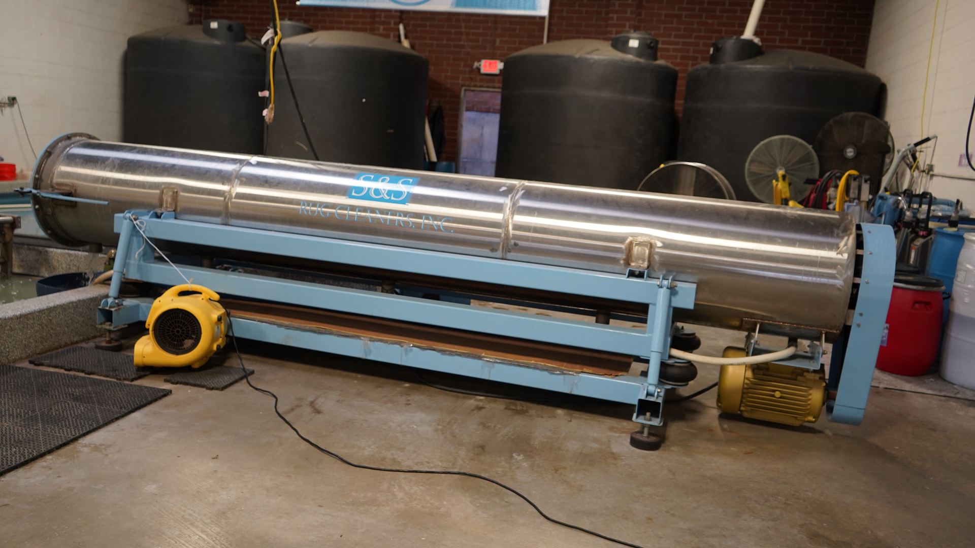 Industrial rug wringer used at the S&S Rug Cleaners Atlanta facility to spin water out of thick shag rugs after washing so they dry quickly