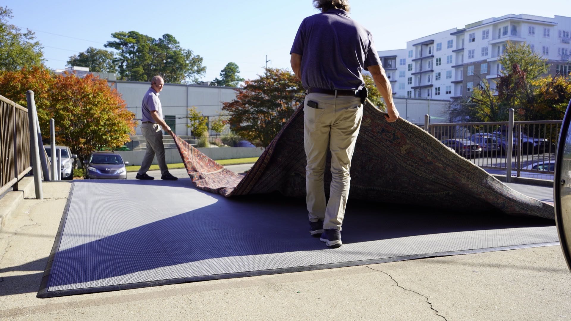 S&S Rug Cleaners team loading a large area rug for free pickup and delivery in metro Atlanta